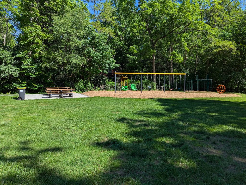 Image of Pauline A. Young park showing picnic benches and playground equipment.